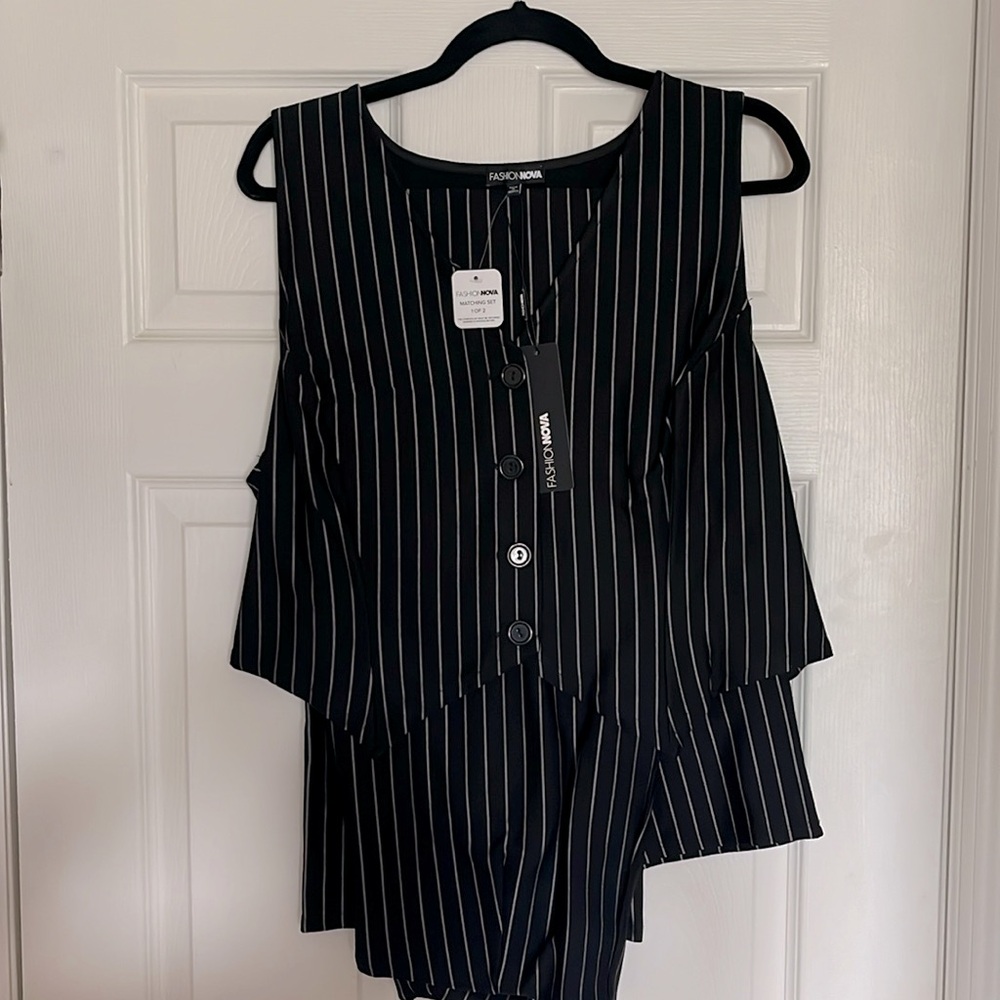 Black and white pinstripe, two piece suit, vest, and flare bottom